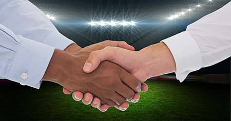 Shaking Hands over Football Field